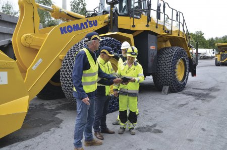 Zleva Jiří Bosák a Daniel Sys (oba KUHN-BOHEMIA) ukazují provoznímu řediteli lomu Prachovice, Karolovi Czubarovi, na tabletu přístup ke stroji skrze systém KOMTRAX.